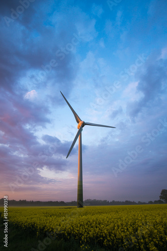 wind wheels at sunrise and fog with dark clouds