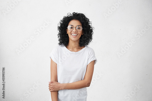 Tablou pe pânză Indoor portrait of charming young mixed race female model dressed casually feeli