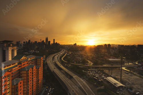 Sky and cloud turn into golden color during sunset overlooking a city where a well built highway giving a unique perspective Capture in landscape format.