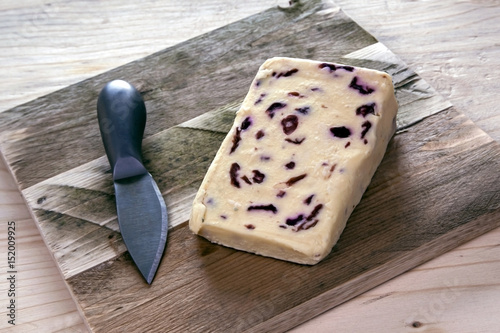 Cheese board with knife and wensleydale cheese. photo