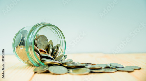 Coins in glass jar for money saving financial concept