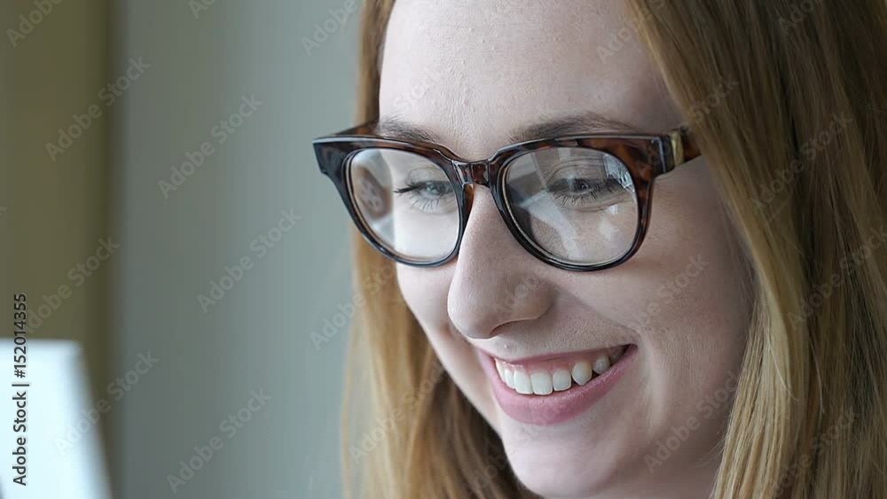 Happy girl wearing glasses and having a videocall on smartphone
Happy girl wearing glasses and having a videocall on smartphone