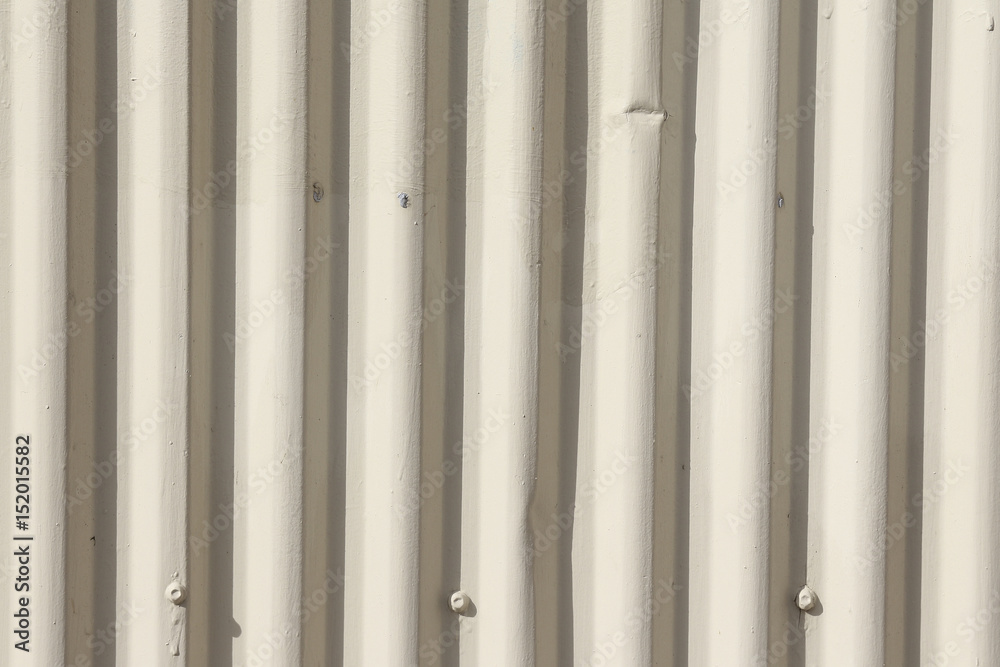 Zinc wall with white cream cracked paint. Texture and background, using a zinc fence. Zinc wall with white cream cracked paint. Texture and background, using a zinc fence.