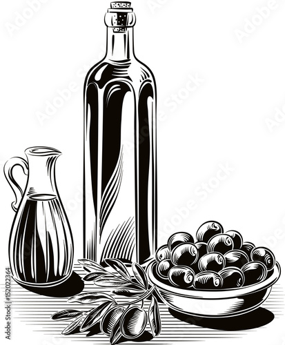 Olives in a bowl, an olive branch, a bottle of extra virgin olive oil and a cruet with olive oil.