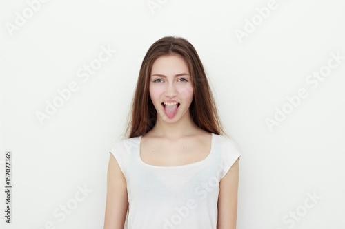 Pretty funny young girl showing tongue