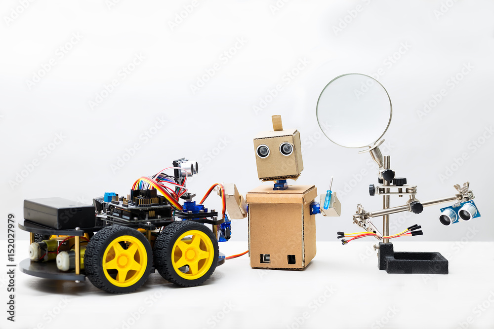 Two robots and parts for assembling a robot on a white background Two robots and parts for assembling a robot on a white background
