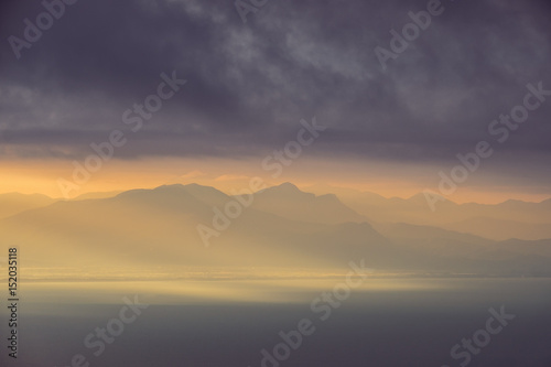 Dramatic landscape view of sunrise over mountains and the ocean