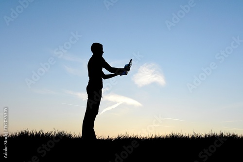 Man on his smartphone in silhouette
