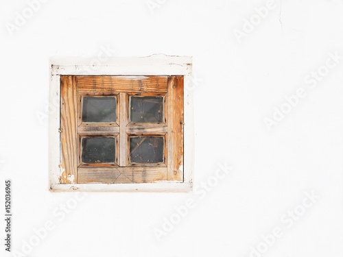 Small wooden window on a white wall, a rustic authentic house, a rural background. Old traditional Ukrainian house, wattle and daub hut. Background with space for text