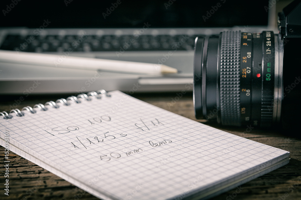 Closeup of a camera and a written notebook