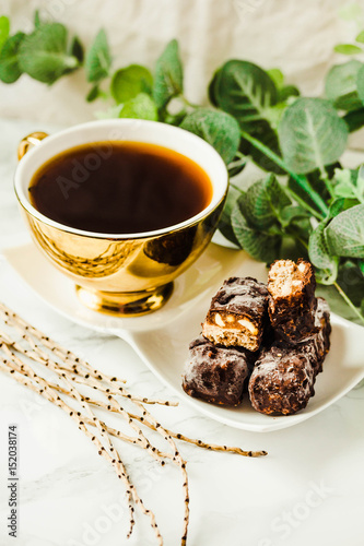 Homemade raw chocolate candy. Snickers bars with cup of coffee.