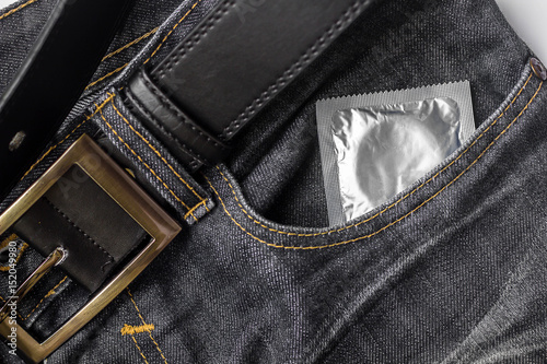 Condom in the pocket of jeans.
