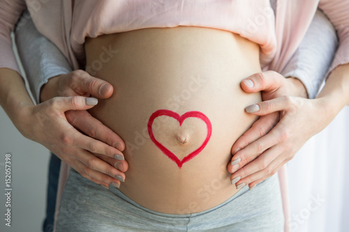Wallpaper Mural Young couple expecting baby standing together indoors Torontodigital.ca