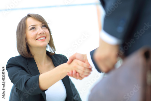 An attractive woman and man business team shaking hands at offic