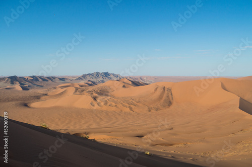 Climbing Big Daddy Dune View onto Desert Landscape, Sossusvlei, Namibia © MilesAstray