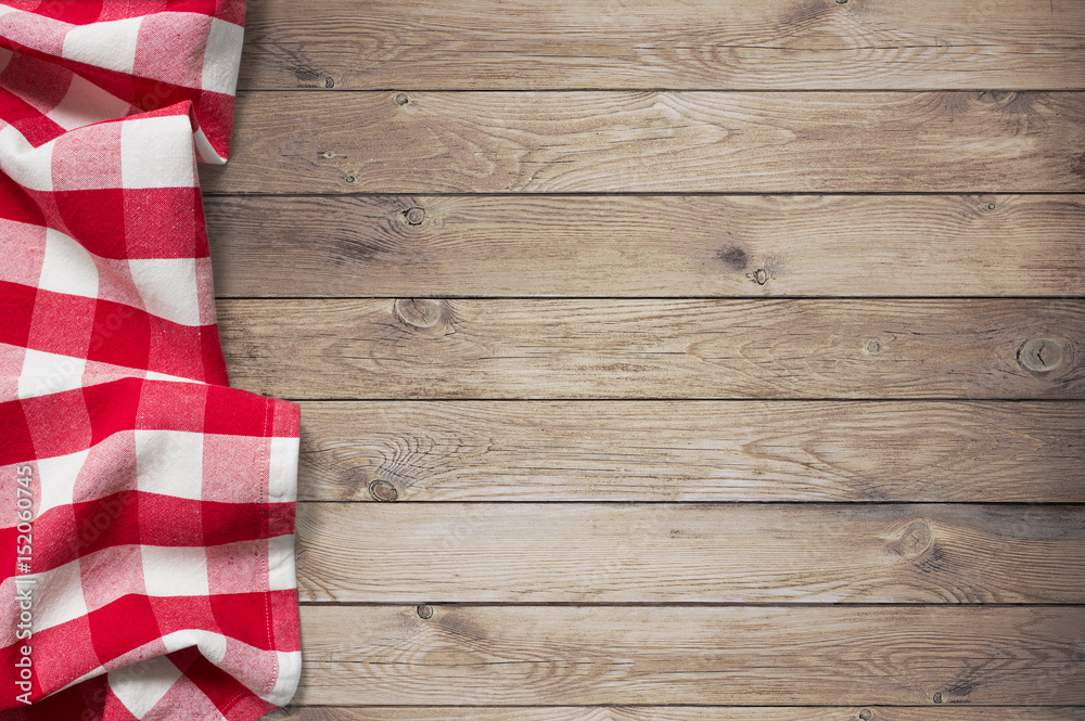 red picnic tablecloth on wood table background red picnic tablecloth on wood table background