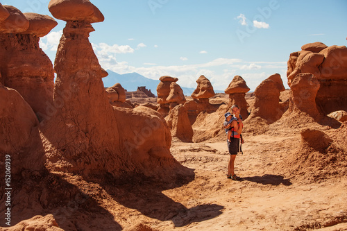 A mother and her baby son visit Goblin valley state park in Utah, USA
