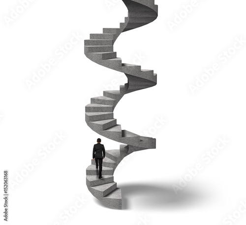 Businessman climbing concrete spiral staircase