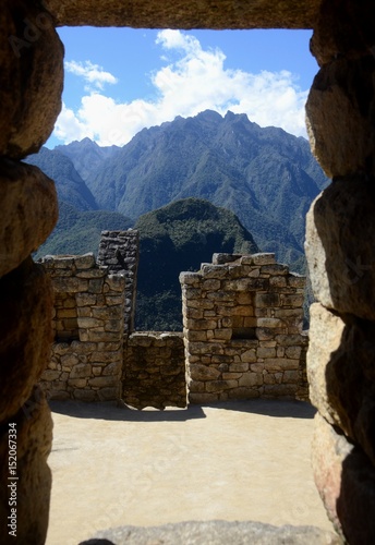 View through a stone doorway out to the surrounding mountains of the Peruvian Amzon.  photo