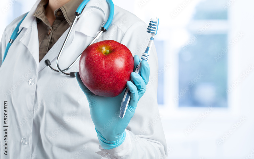 dentist holding a ripe apple