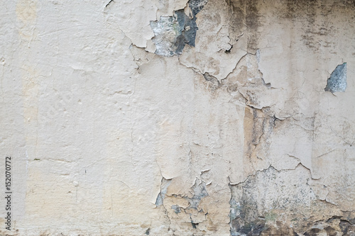 concrete wall texture and plaster falling off. Warm pastel background texture