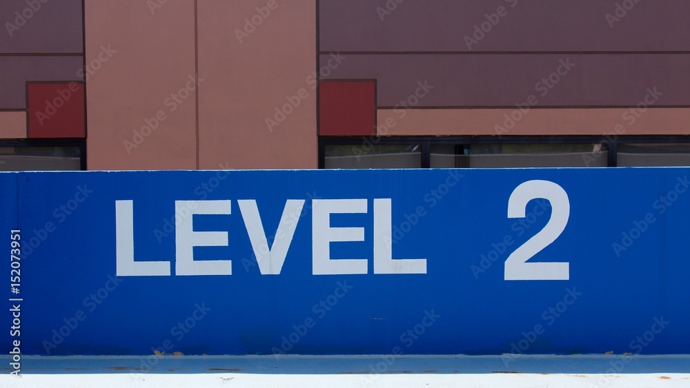 Level 2 painted blue on the short cement wall. Level 2 painted blue on the short cement wall.