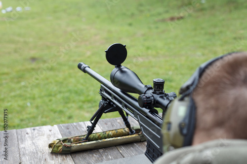 A man sniper prepares to shoot at the target.