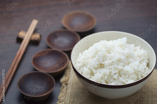 Thai rice with chopsticks on wood background