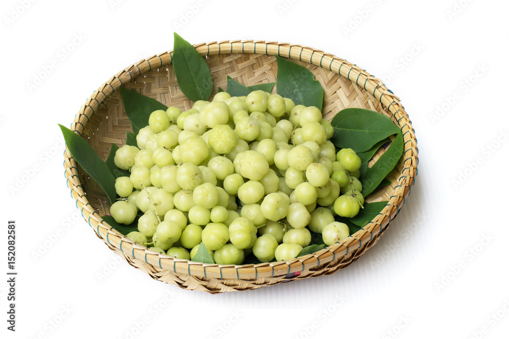 top view fresh Phyllanthus acidus or star gooseberry with green leaves on bamboo basket background top view fresh Phyllanthus acidus or star gooseberry with green leaves on bamboo basket background