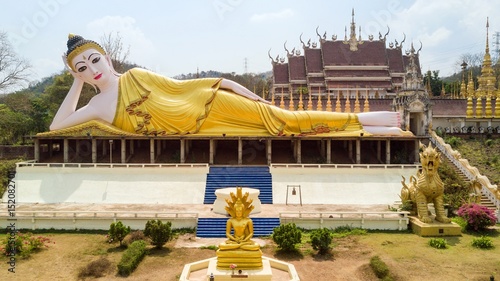 Thai buddhist temple wirh golden reclining statue photo