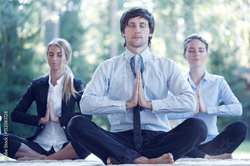 Fototapeta Naklejka Na Ścianę i Meble -  Business people practicing yoga