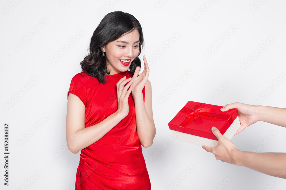 Beautiful happy asian woman in red dress receiving gift box Beautiful happy asian woman in red dress receiving gift box