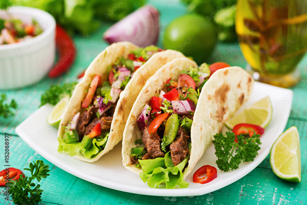 Mexican tacos with beef in tomato sauce and salsa Mexican tacos with beef in tomato sauce and salsa