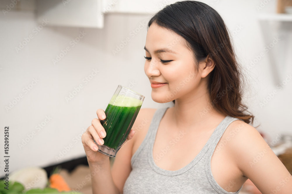 Young asian woman enjoy healthy vegetarian smoothie for weight loss and detox Young asian woman enjoy healthy vegetarian smoothie for weight loss and detox