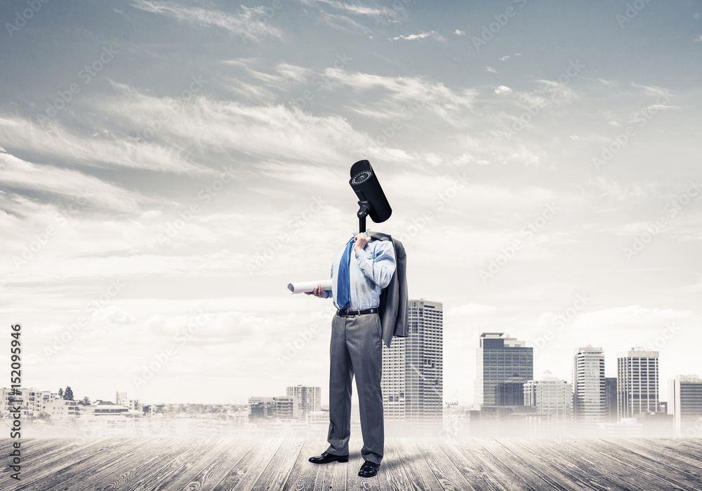 Camera headed man standing on wooden floor against modern citysc Camera headed man standing on wooden floor against modern citysc