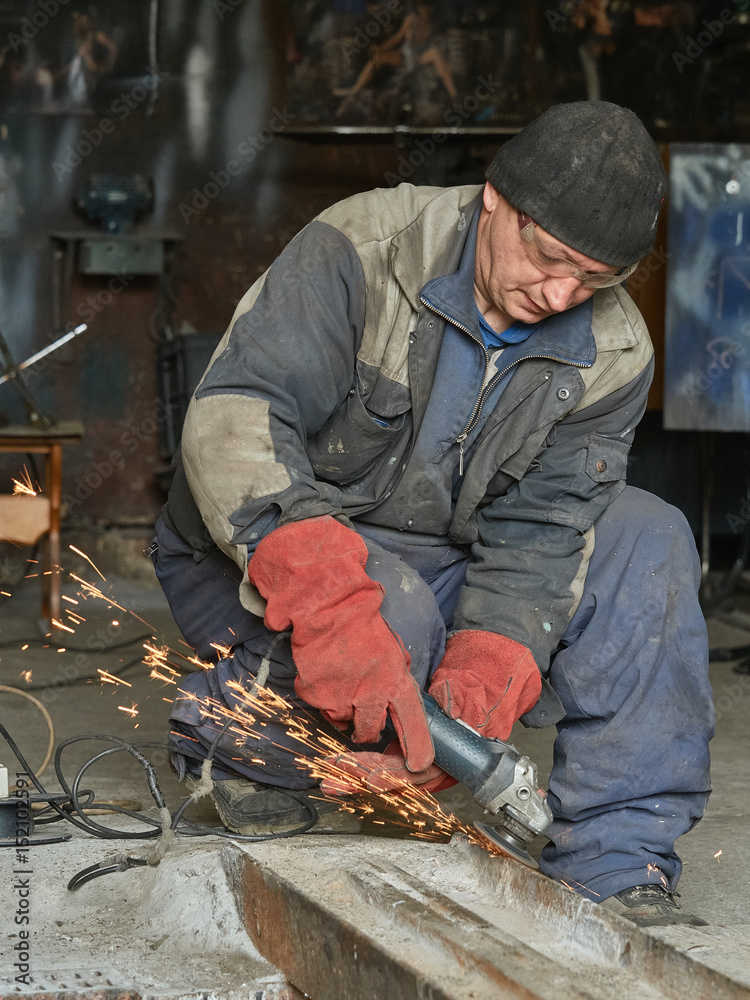 Grinding metal rail by the angle-grinding machine. Grinding metal rail by the angle-grinding machine.