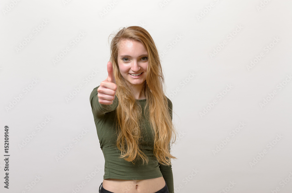 Enthusiastic motivated blond woman giving a thumb up Enthusiastic motivated blond woman giving a thumb up