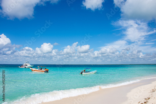 Speed boats on clear beautiful ocean with sky and cloud background