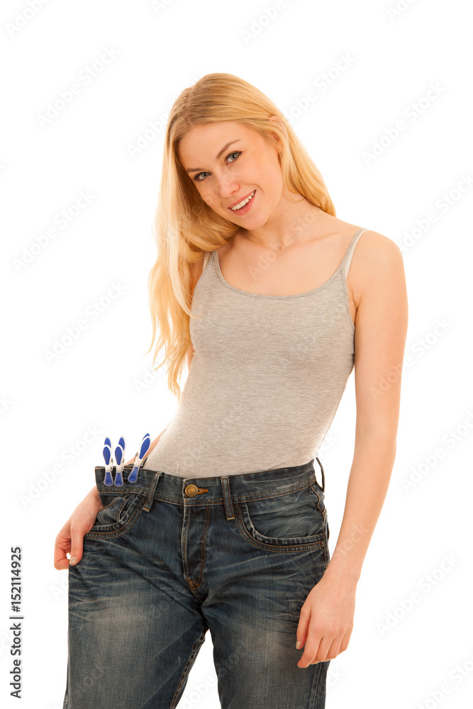 Young woman wearing too big trousers as she lost weight