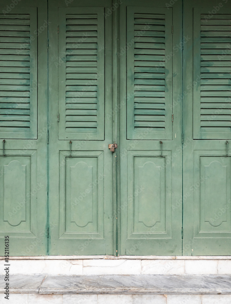 Wooden folding doors with the small lock.