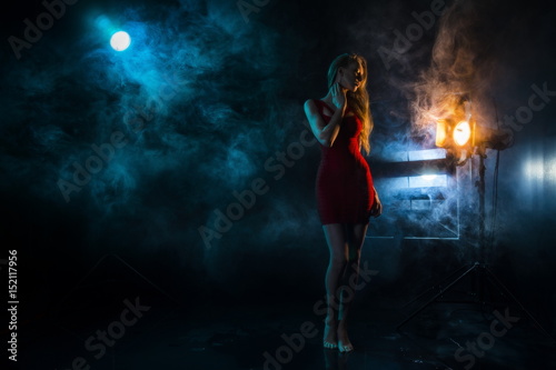 the girl s silhouette in fog against the background of light sources