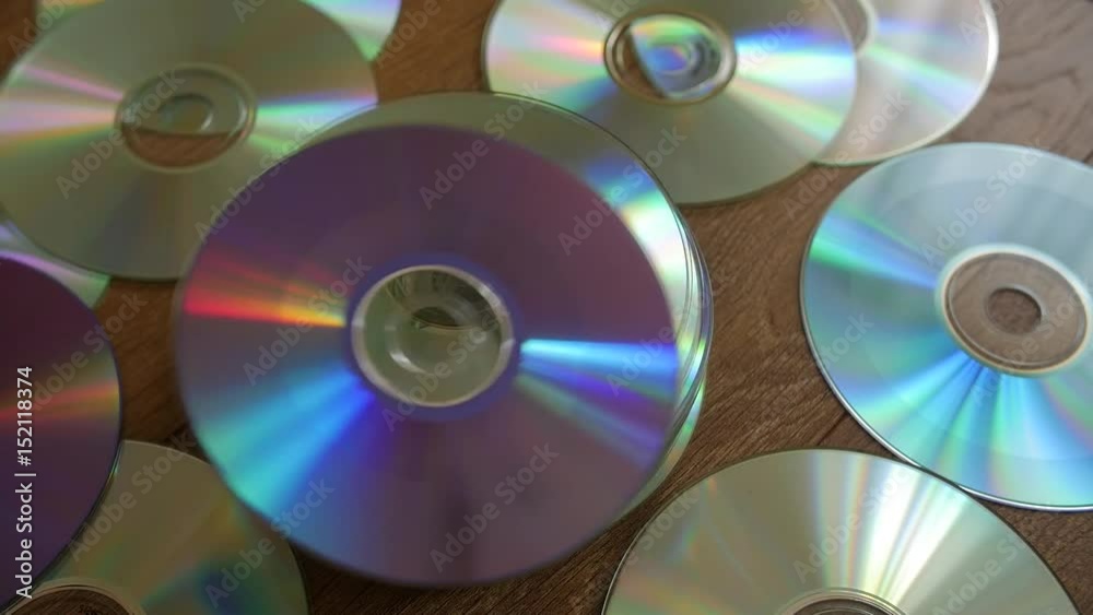 Optical Discs falling onto big pile of DVDs or CDs. Slow motion. Optical Discs falling onto big pile of DVDs or CDs. Slow motion.