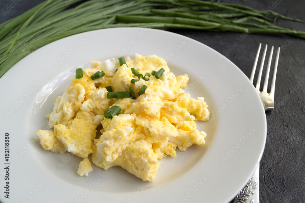 scrambled eggs on a white plate. the view from the top.