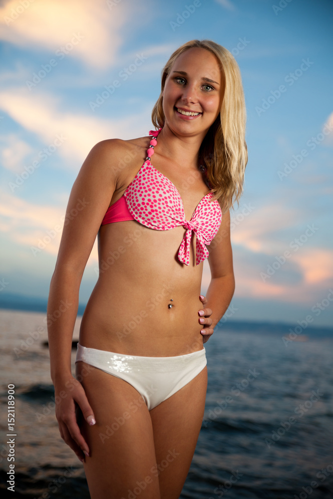 Young woman on the beach at sunset on a hot summer day Young woman on the beach at sunset on a hot summer day