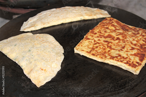 Turkish Gozleme. Gozleme is a traditional Turkish dish featuring flat bread stuffed with a range of delicious fillings. Baked on sheet iron.