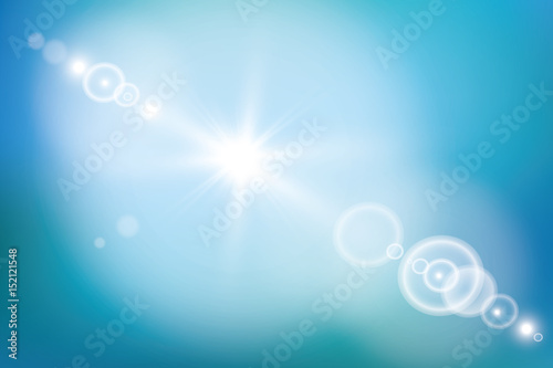 bright sun on blue sky background with lens flare
