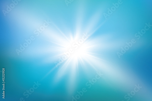 bright sun on blue sky background with lens flare 