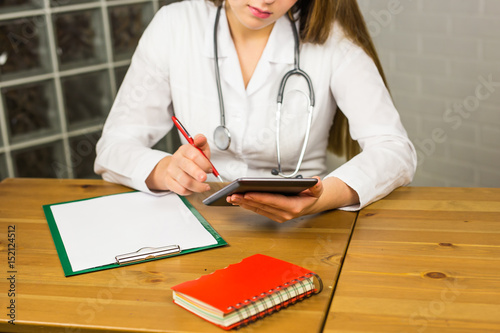 Close-up of doctor using a tablet computer in a hospital photo