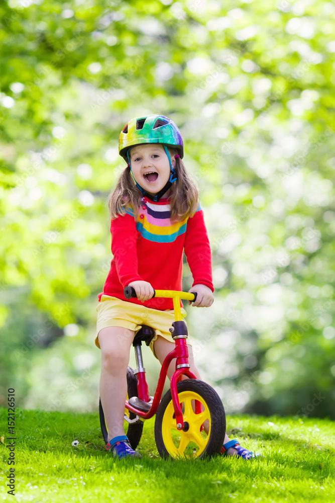 Kids ride balance bike in park Kids ride balance bike in park
