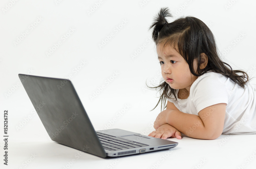 Asian child playing on computer laptop Asian child playing on computer laptop